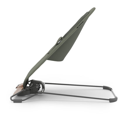 Side view of UPPAbaby baby bouncer in olive green fabric with wood accent base