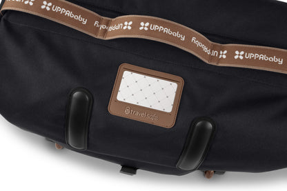 Black UPPAbaby travel bag with brown branded strap and TravelSafe luggage tag