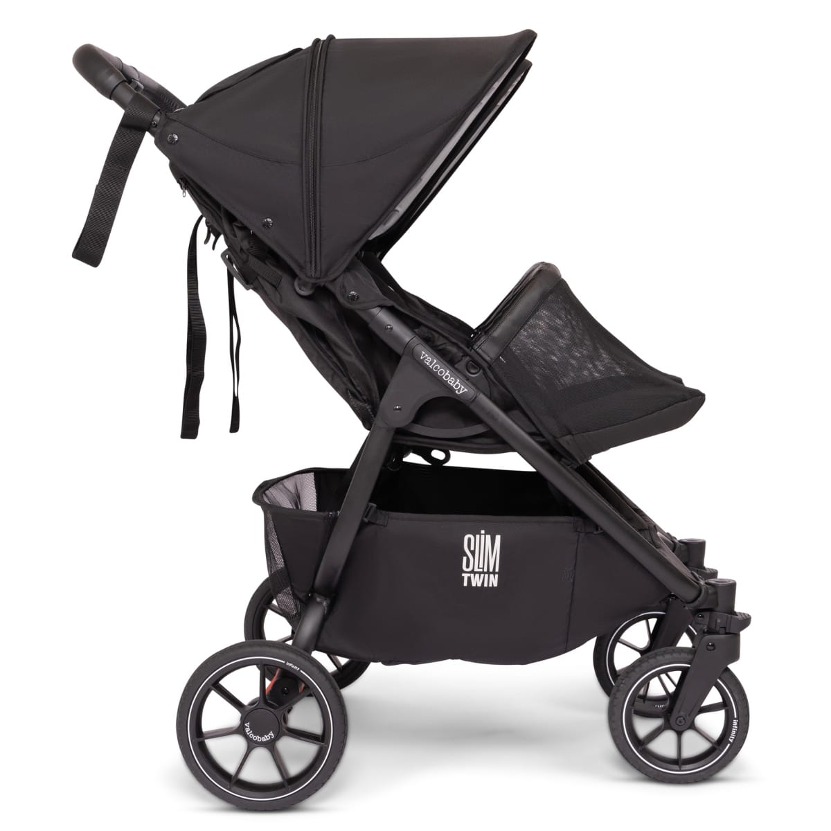 Side profile of a black Valco Baby Slim Twin stroller with storage basket and canopy