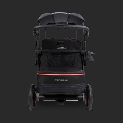 Rear view of WonderFold Porsche stroller wagon with black canopy and red light bar