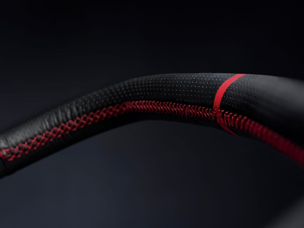 WonderFold stroller handlebar with black perforated leather and red cross stitching